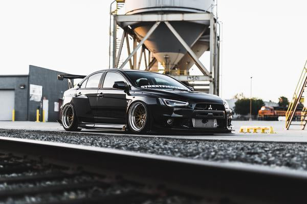 front side angled view of black EVO X with Custom Wide Body Kit