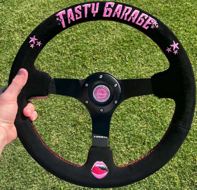 NRG Reinforced Steering Wheel | 350mm | 3" Deep Dish | Tasty Garage Second Signature Series| Black Suede Grip w/ Red Stitching | Pink TG Embroidery