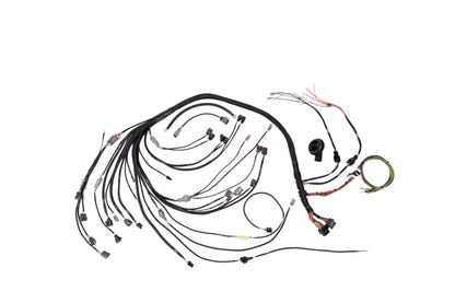 An automotive wiring harness kit with multiple black-wrapped wires, various connector types, and small attached components, laid out on a plain white background.